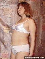 Mature blonde undresses and poses