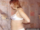Mature blonde undresses and poses