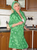 Mature housewife undressing in the kitchen