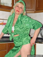 Mature housewife undressing in the kitchen
