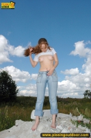 Teeb blonde pisses outdoor on rocks