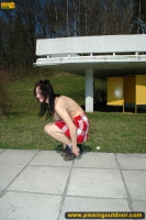 Teen brunette pissing in the park