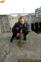 Teen blonde pissing outdoor in the city pond