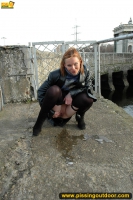 Teen blonde pissing outdoor in the city pond