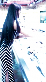 Sexy filipino babe in long striped skirt shopping for meat