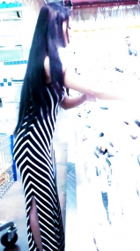 Sexy filipino babe in long striped skirt shopping for meat