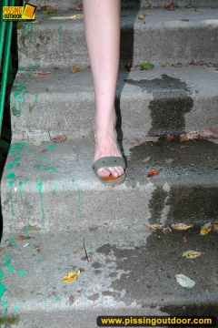 Outdoor pissing of teen brunette on a concrete park ladder - N