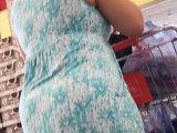 Spy camera video of a mature woman in a long dress walking